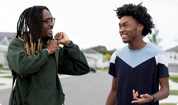 Two young people talking outside